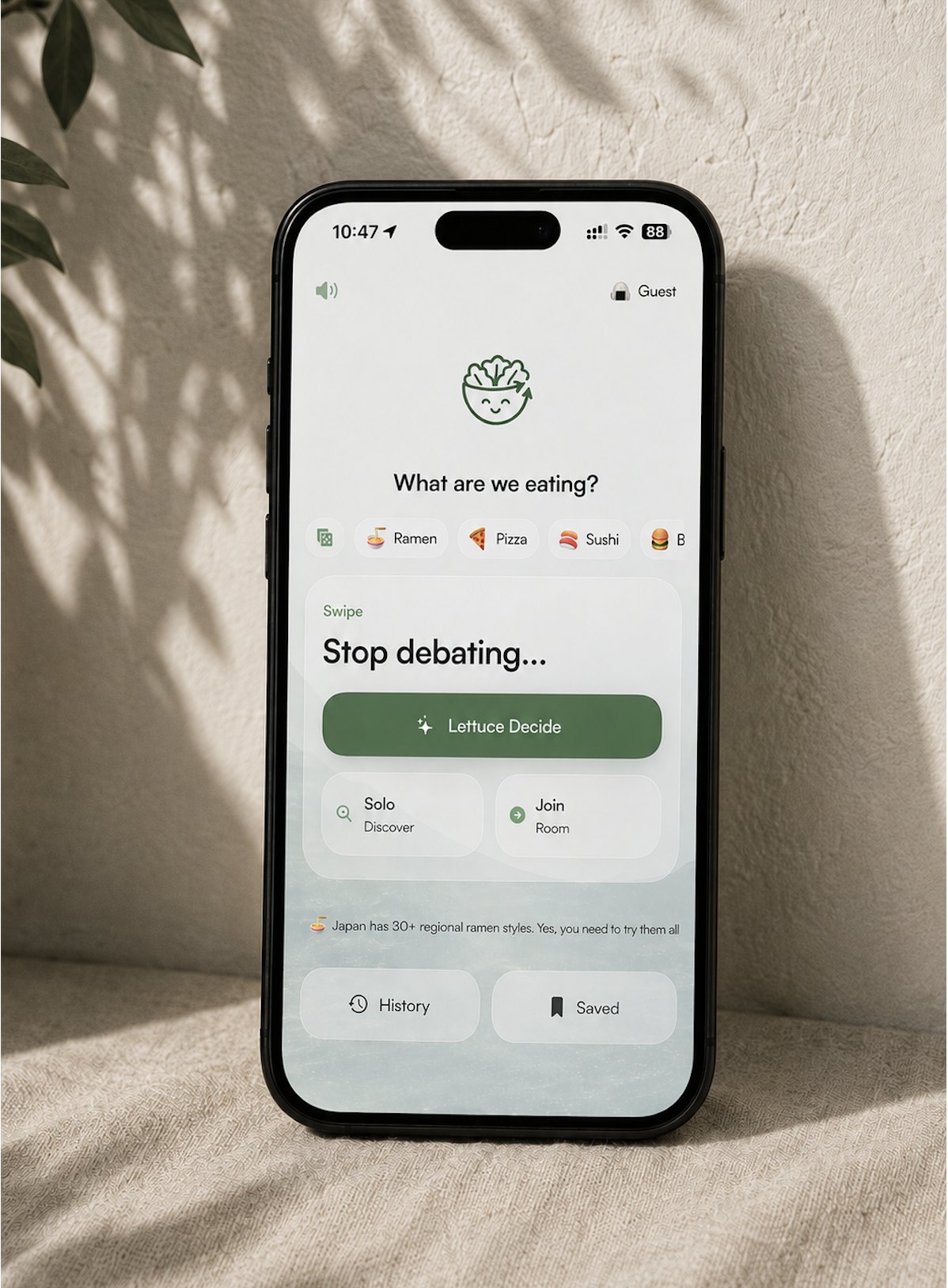 Lettuce Decide app screenshot displayed inside a black phone with fabric around it