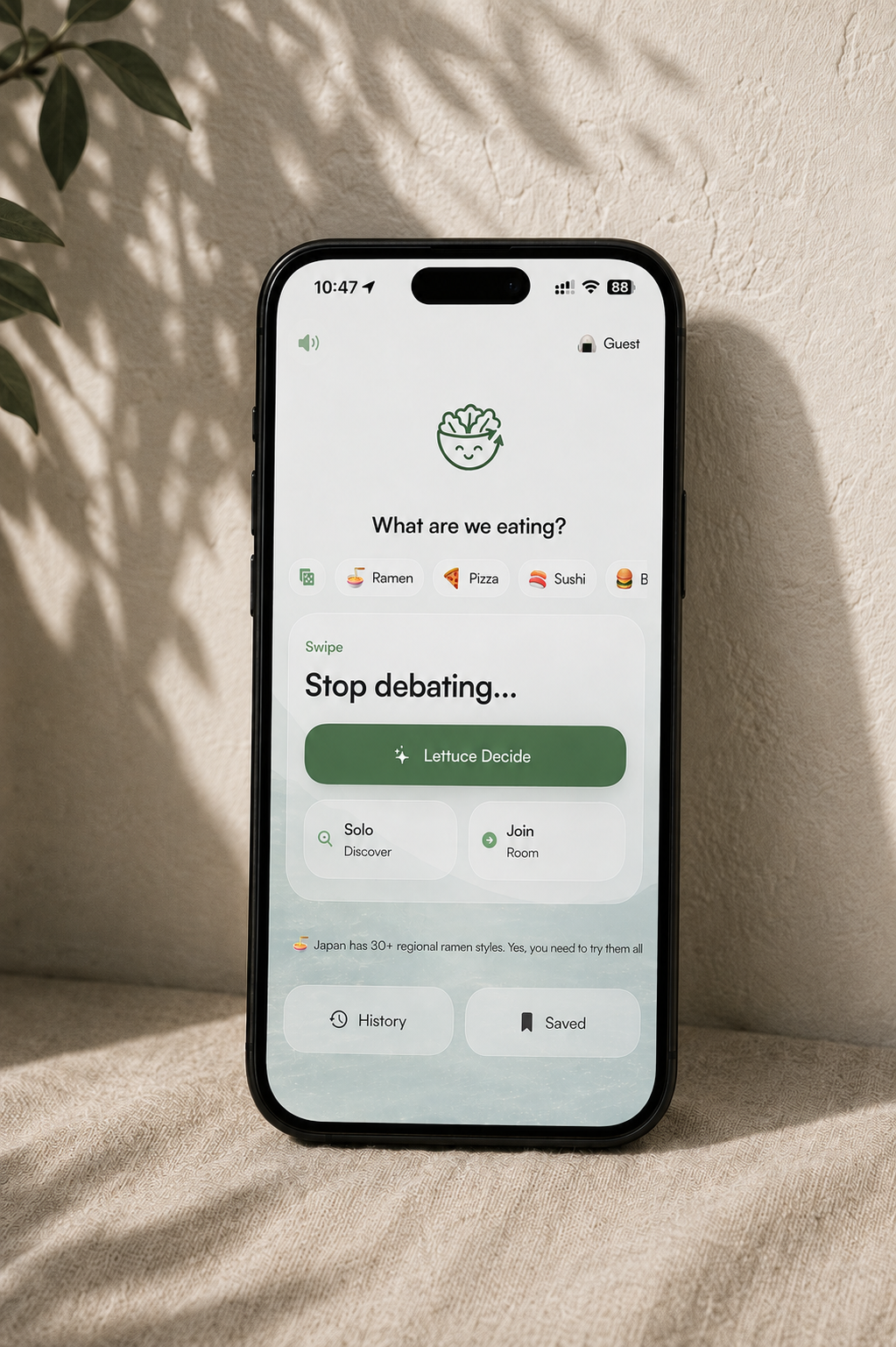 Lettuce Decide app screenshot displayed inside a black phone with fabric around it